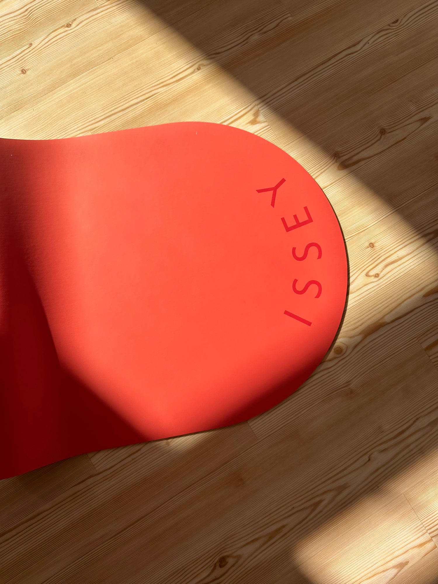 pink eco yoga mat with the brand name 'ISSEY' printed on it.