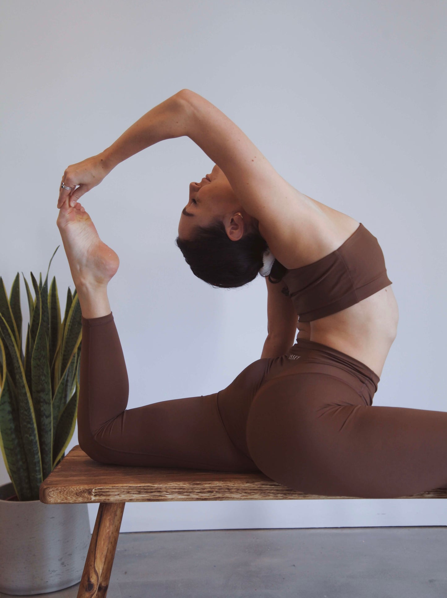 yoga pose, back bend in brown yoga set
